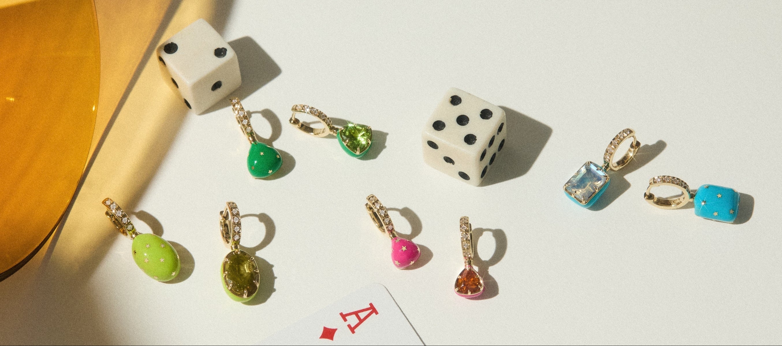 Gemstone, gold and diamond earrings with star pattern in colorful enamel